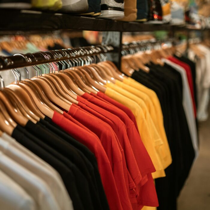Clothing store display with shirts hanging neatly on a rack indoors.