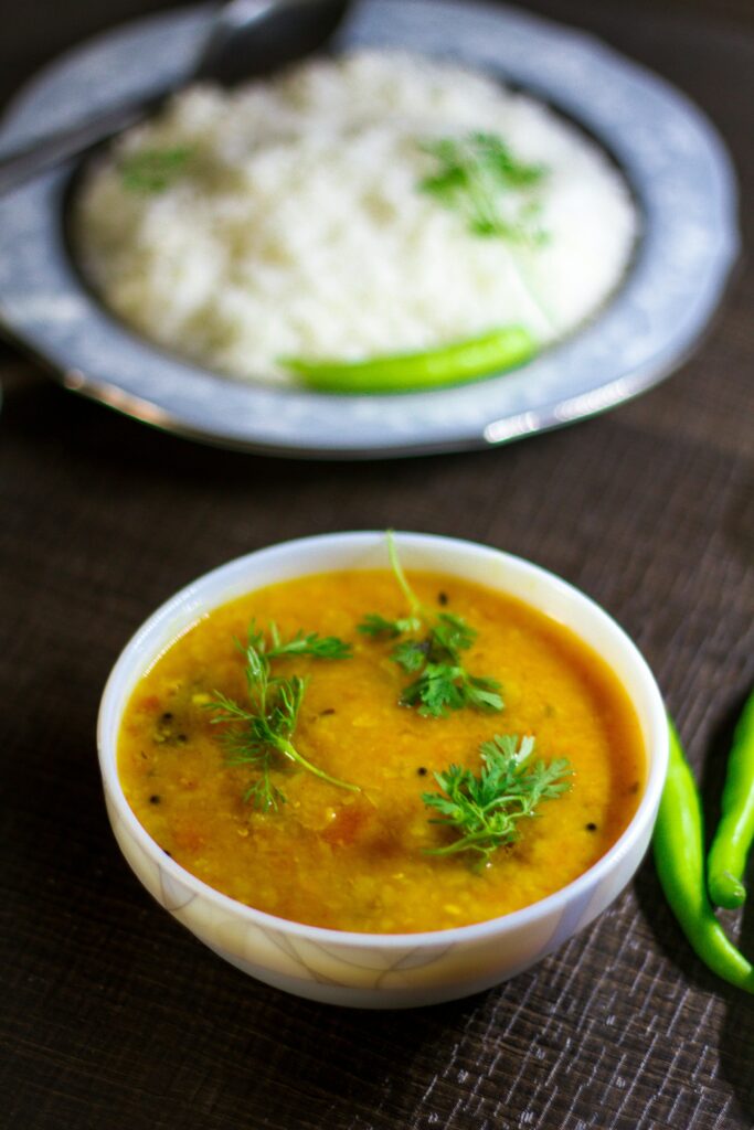 Delicious Hyderabadi dal with aromatic spices served with rice and garnished with green chilies.