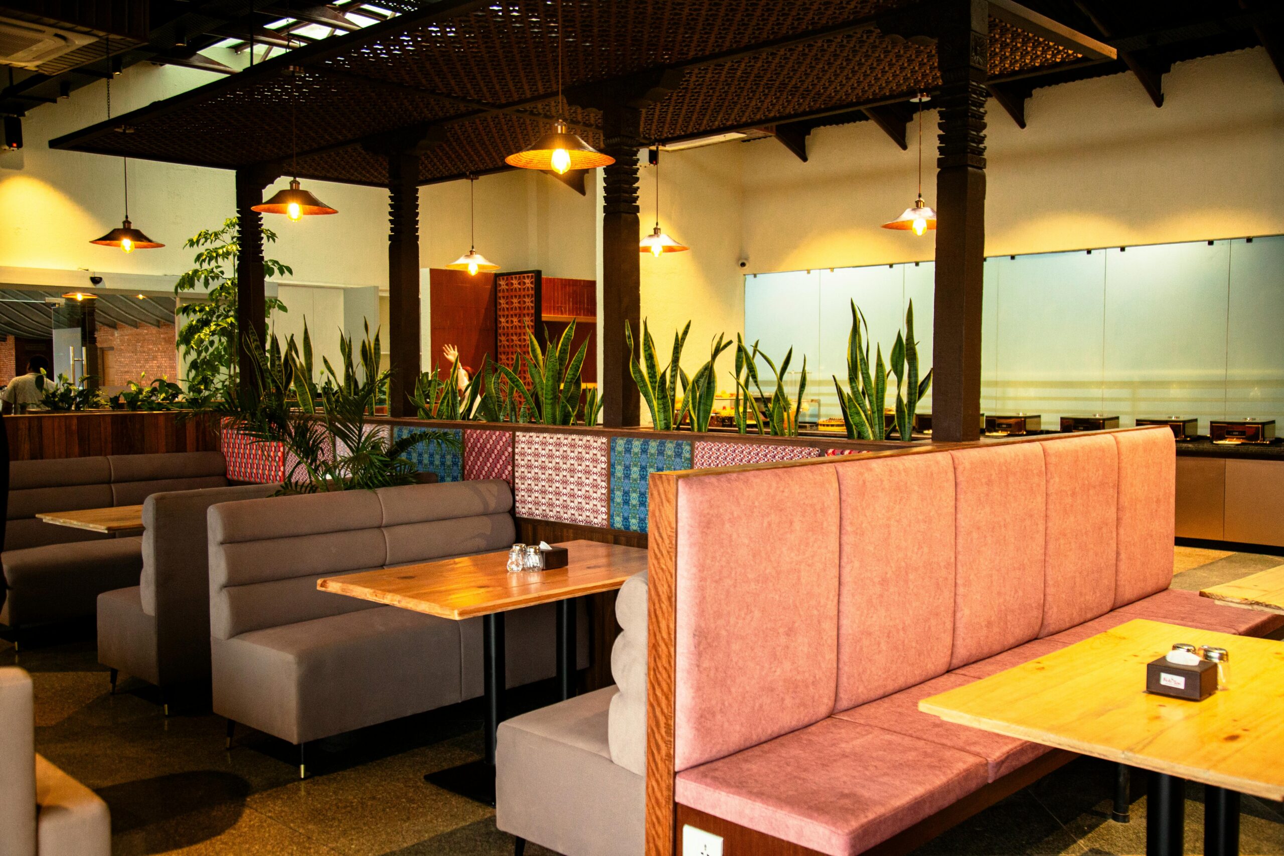 Warm, inviting restaurant interior showing empty booths and vibrant decor.