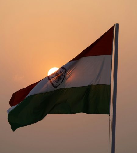 The Indian national flag waves majestically against a sunset backdrop, symbolizing patriotism in Lucknow.